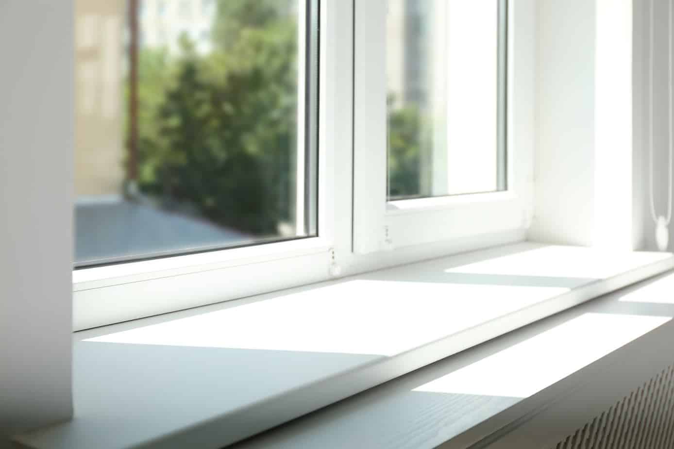 all white window sill with sun shining in