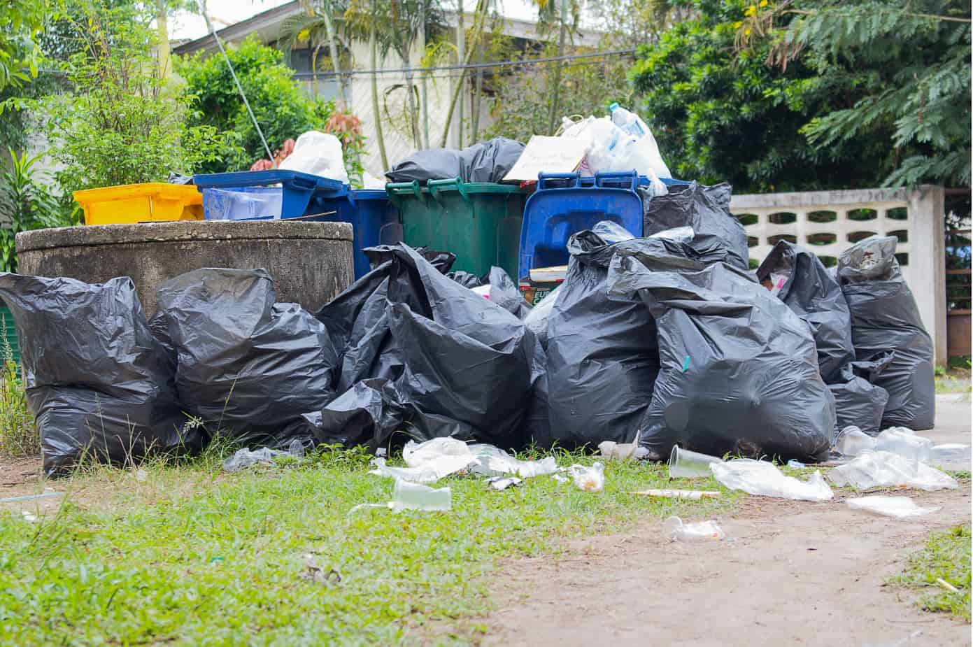 large black rubbish bags outside the front of a house