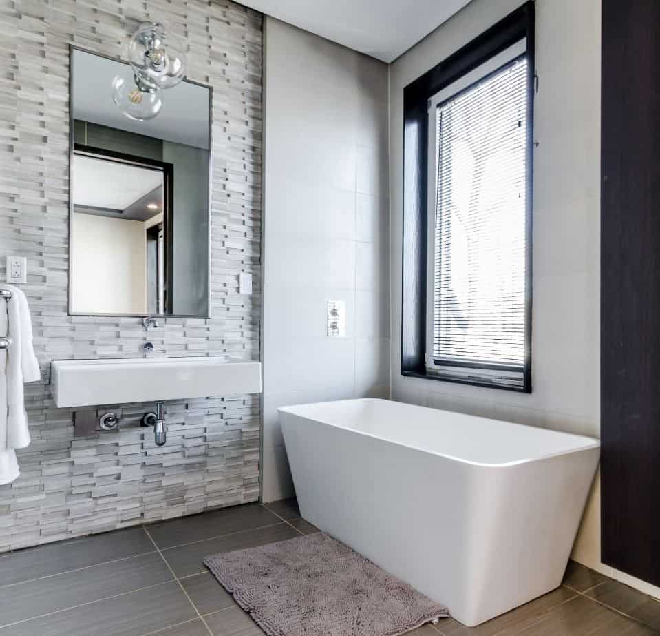 Large white rectangular bathtub in a modern bathroom