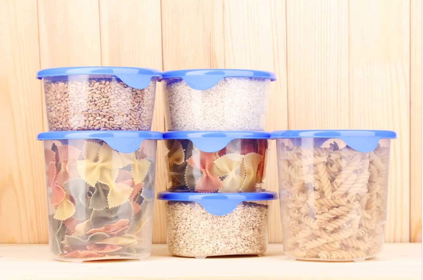 six plastic tupperware containers filled with assorted dried food