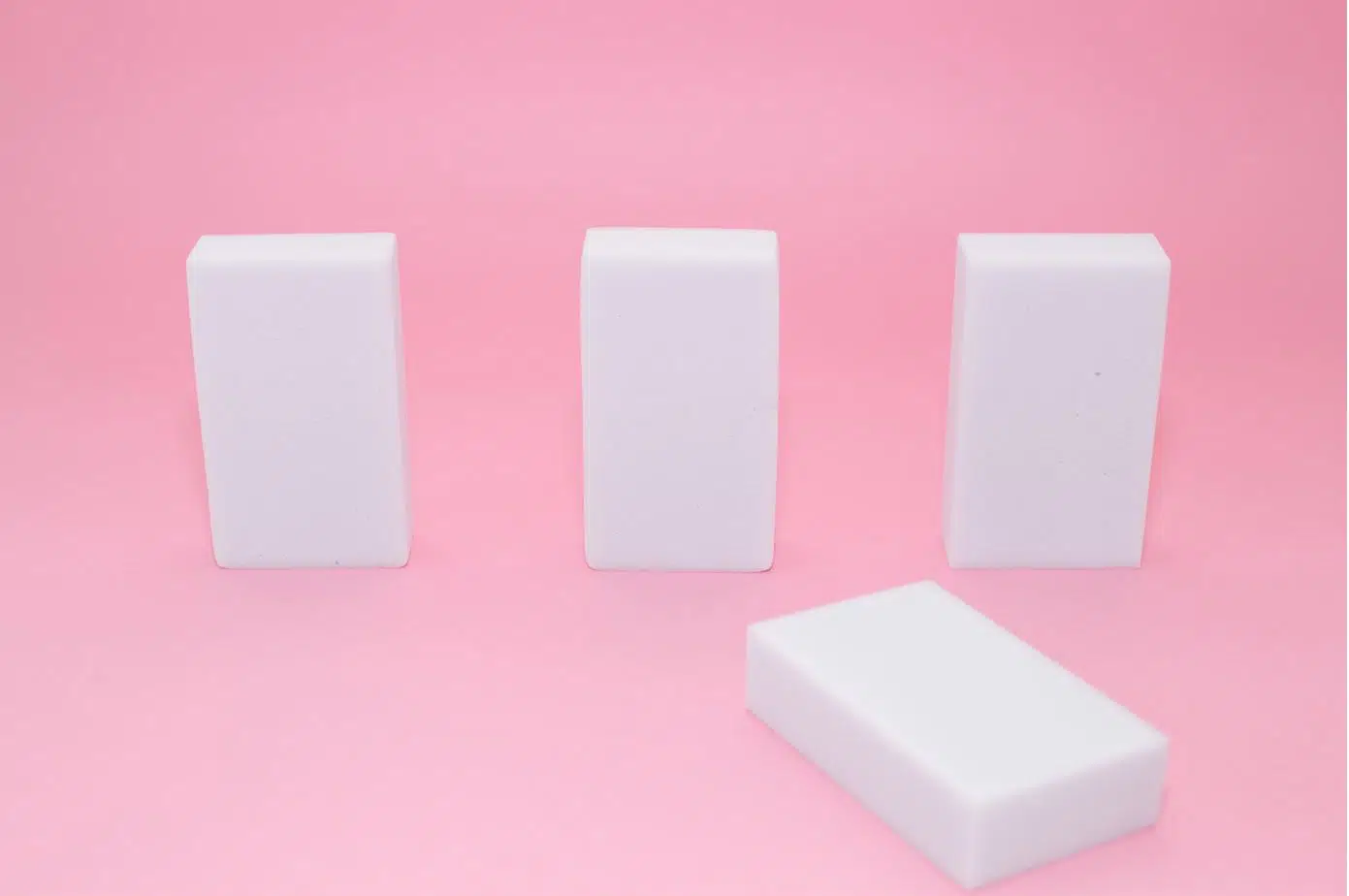 4 melamine sponges on a pink background