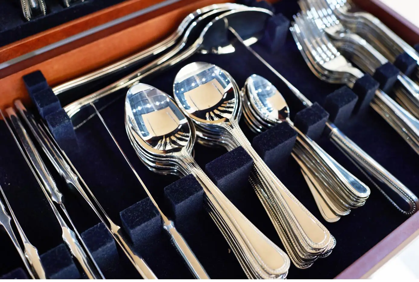a box of silver forks spoons and knives