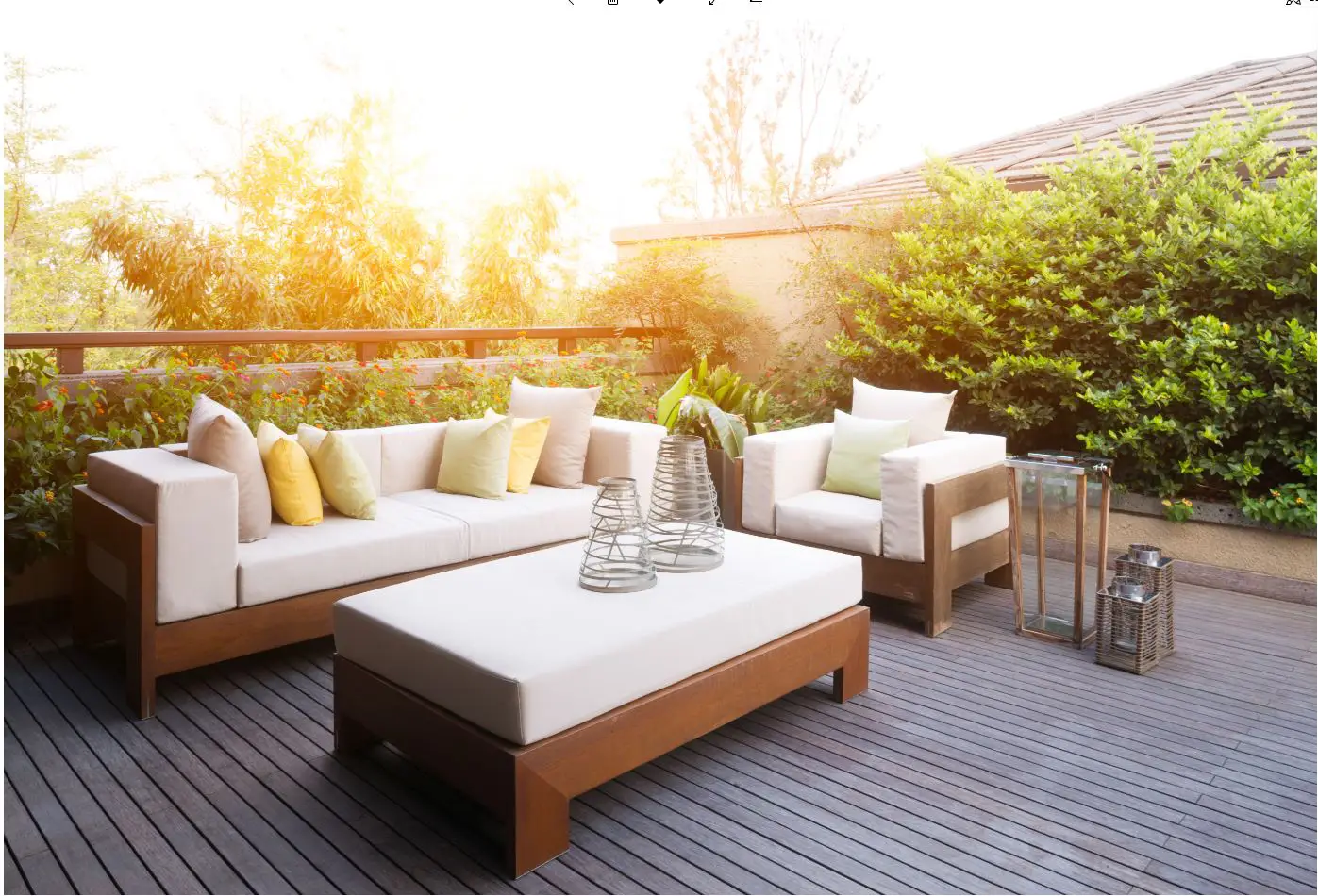 a two seater outdoor couch next to a single seater outdoor sofa and coffee table