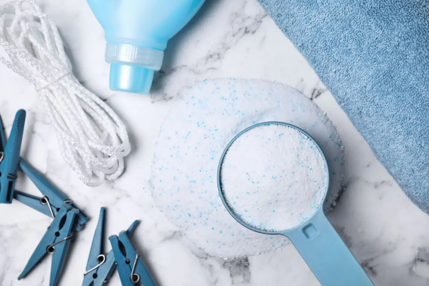 assorted blue laundry detergent on a white marble benchtop