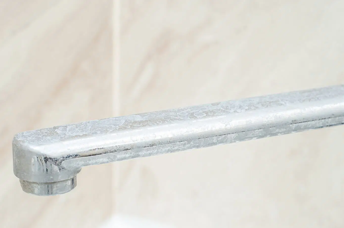 bathroom basin tap that is heavily stained with soap scum