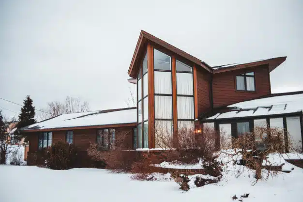Brown house with big windows in winter