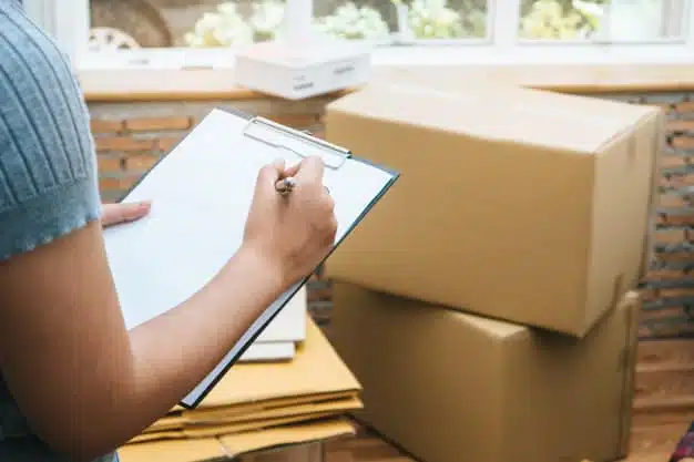Woman checking stuff cardboard boxes
