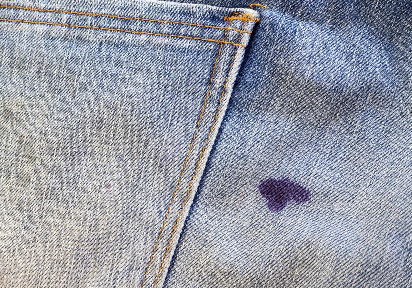 Ink stain on the backpocket of faded denim jeans