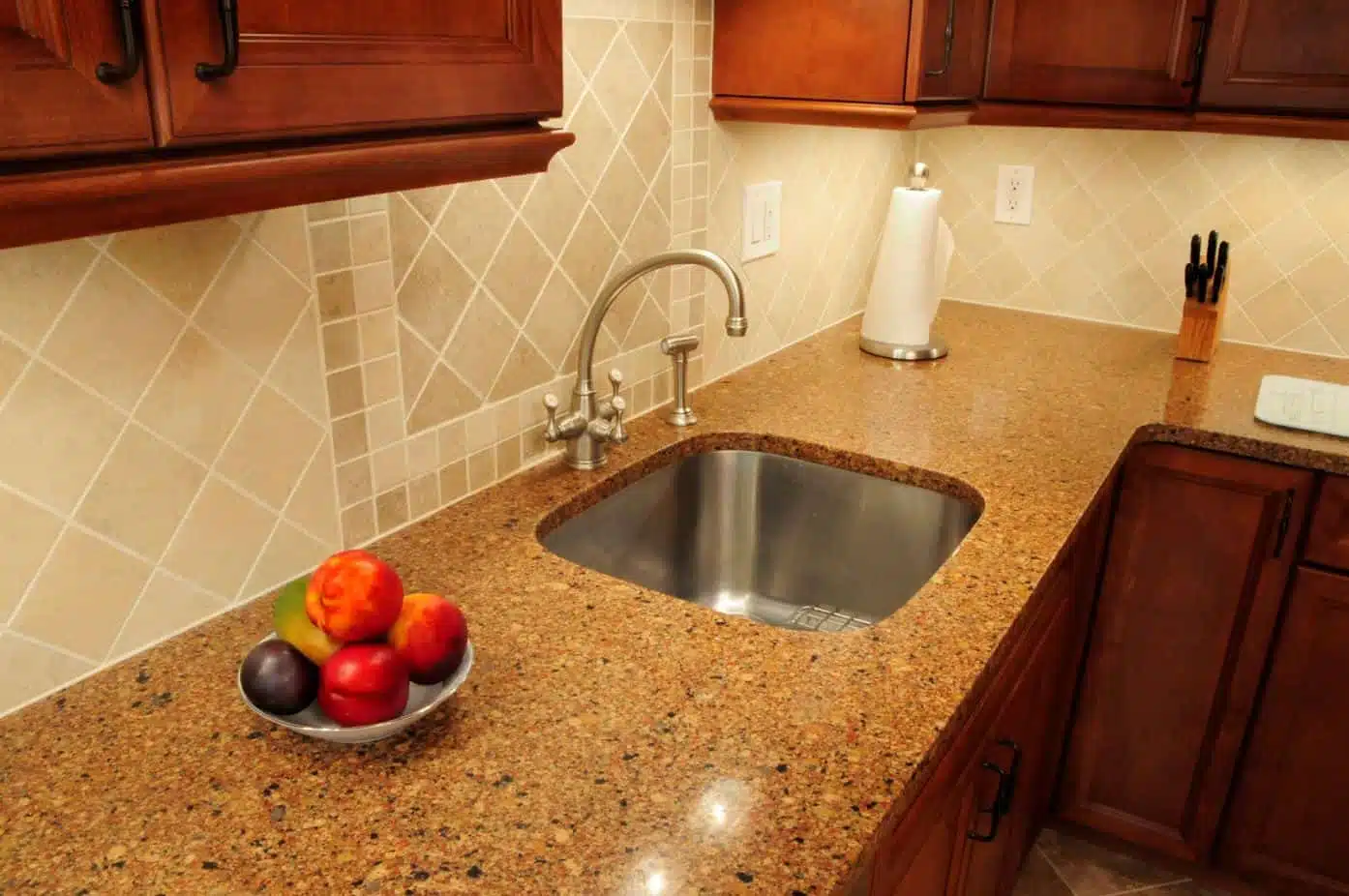 kitchen countertop with a bowl of fruit on top