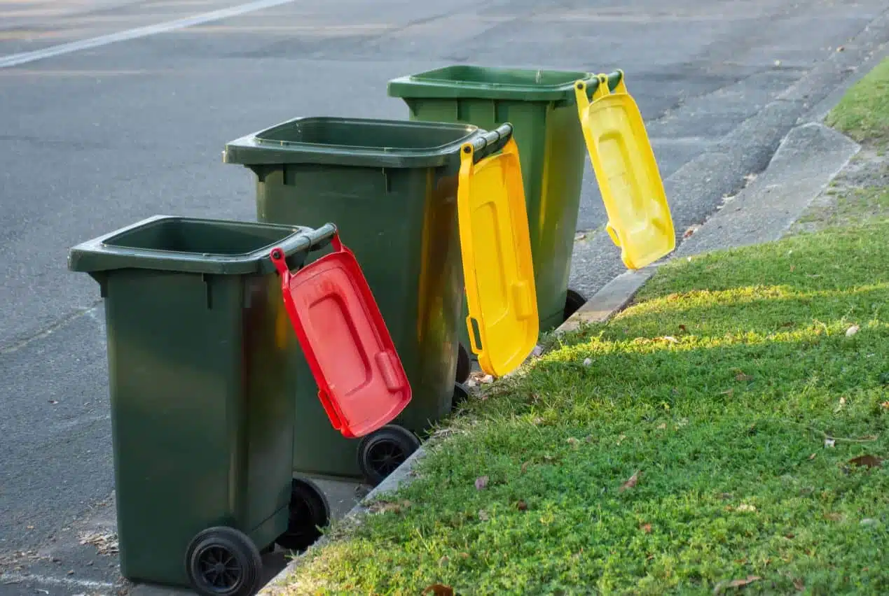 three wheelie bins on a curb