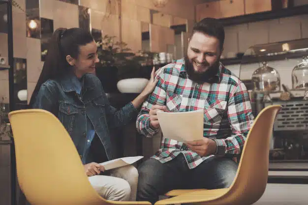 young-people-studying-documents-while-cafe